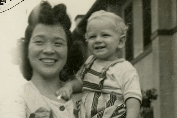 Japanese nanny holding American child