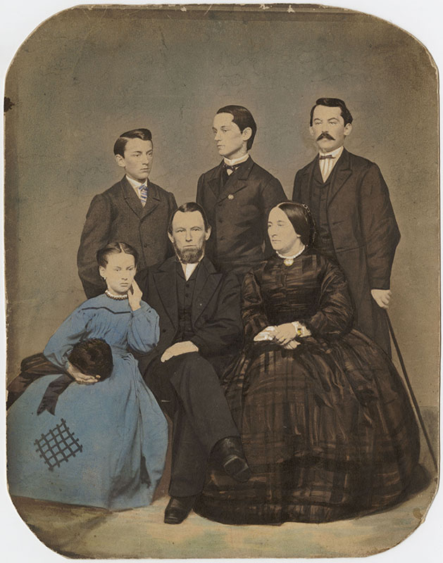 Father, Mother, three sons, and a daughter posing for a family photograph