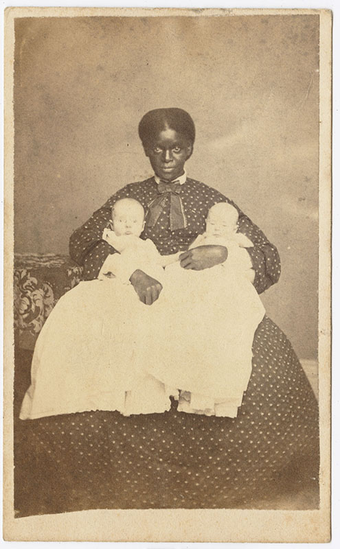 Black young woman holding two white babies