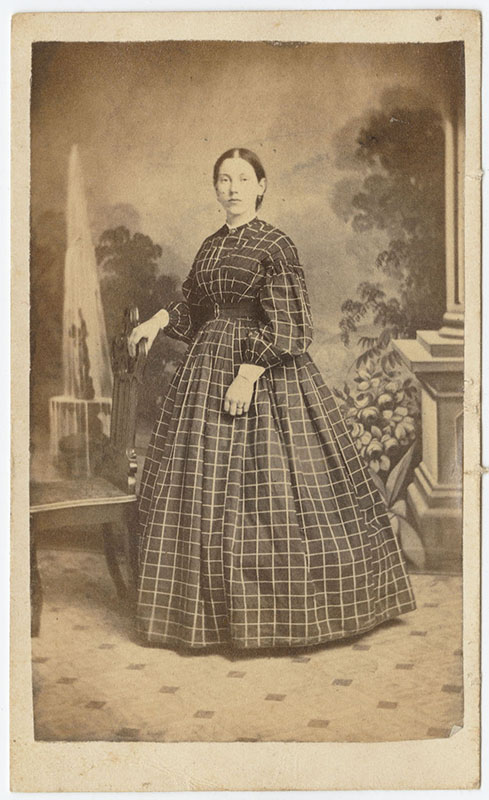 Portrait of a woman with a painted garden scene as a backdrop