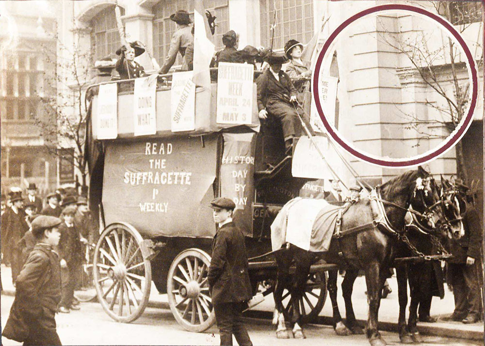 Women suffrage activists on a stage coach in the street