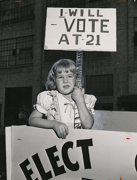 girl with vote at 21 sign