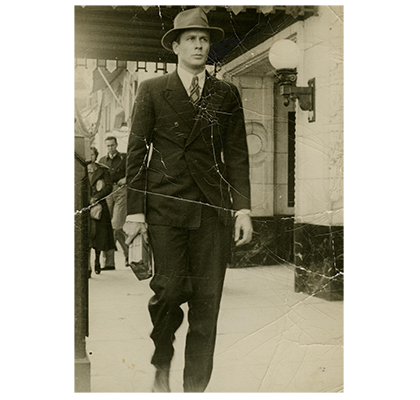 Albert Erskine dressed in suit, tie, and hat.