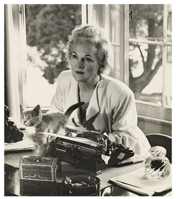 Katherine Anne Porter with typewriter and Juniper the kitten.