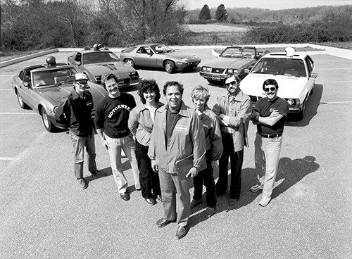 Motorweek cast and crew, circa 1982. Left to right: Jerry Pilachowski, Craig Singhaus, Argiro Sarantinos-Perrin, John Davis, Lane Stiegelman, Rick Winter, Max Balotin