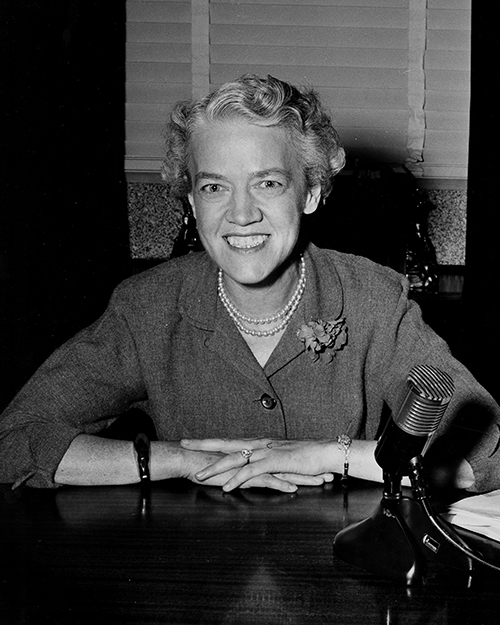 Senator Margaret Chase Smith seated behind desk