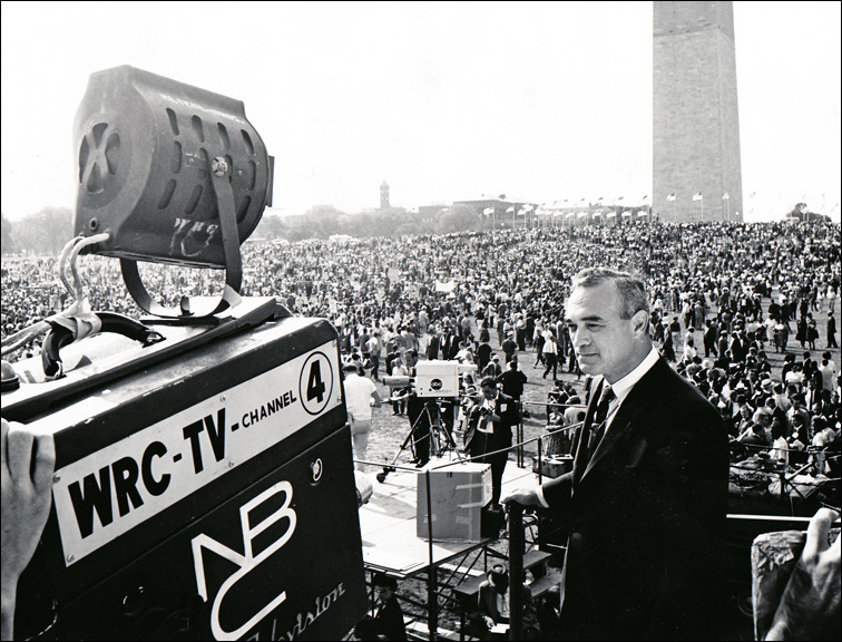 Martin Agronsky standing in front of crowd in front the Washington Monument in Washington DC