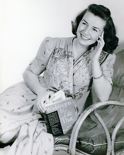 Portrait of Ann Corrick, posing with a book