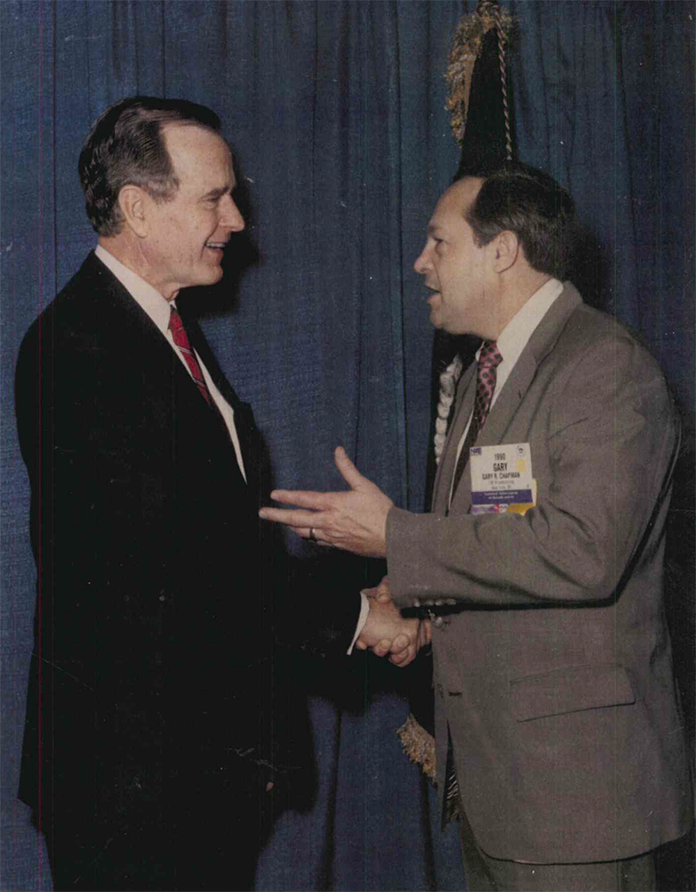 Photo of Gary Chapman shaking hands with President George H. W. Bush