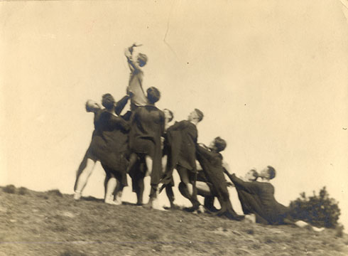 Group on hill with woman aloft
