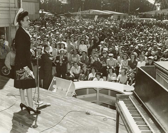 Lena Horne on stage in front of a large crowd.