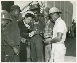 Lena Horne signing a photograph for shipworkers