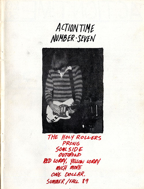 Action Time 7 cover with a photo of a man playing an electric guitar and band names written in red ink underneath it.