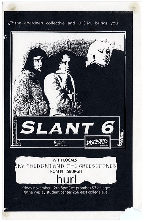 Black flier with a large black and white photo at center of the three members of Slant 6 looking to the side with neutral expressions wearing coats.