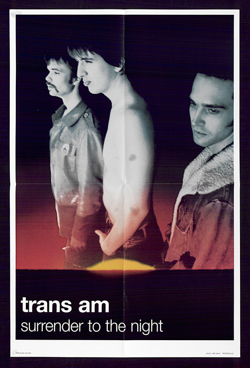 A poster with a large photograph of the members of trans am, one posed shirtless, standing and looking leftward. Text is below in black and white lowercased Helvetica.