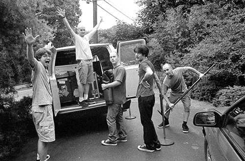 Members of the band Fugazi load their van with musical equipment